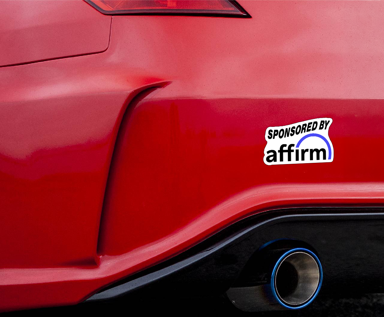 Red car with 'Sponsored by Affirm'